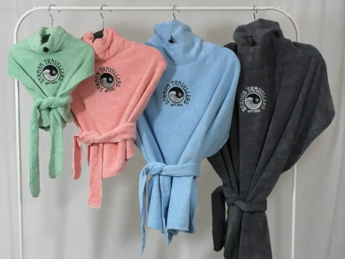 A group of towels hanging on a rack.