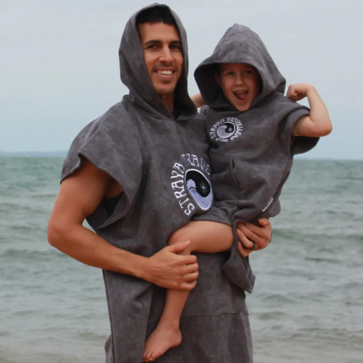 A man and child in the water with towels on